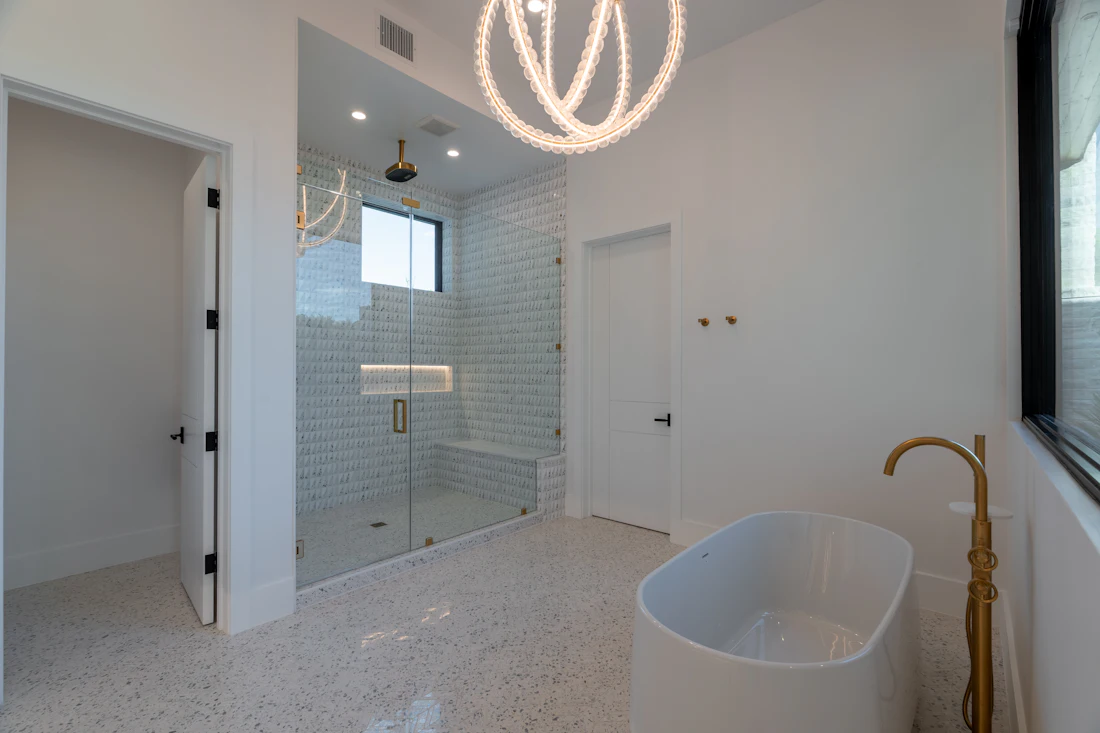 Custom glass shower enclosure in a white bathroom