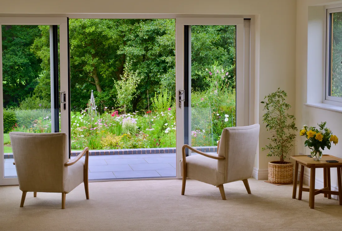 Glass patio doors opening onto a garden