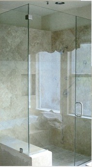 Frameless glass shower enclosure with marble walls, installed by JP Glass & Mirror